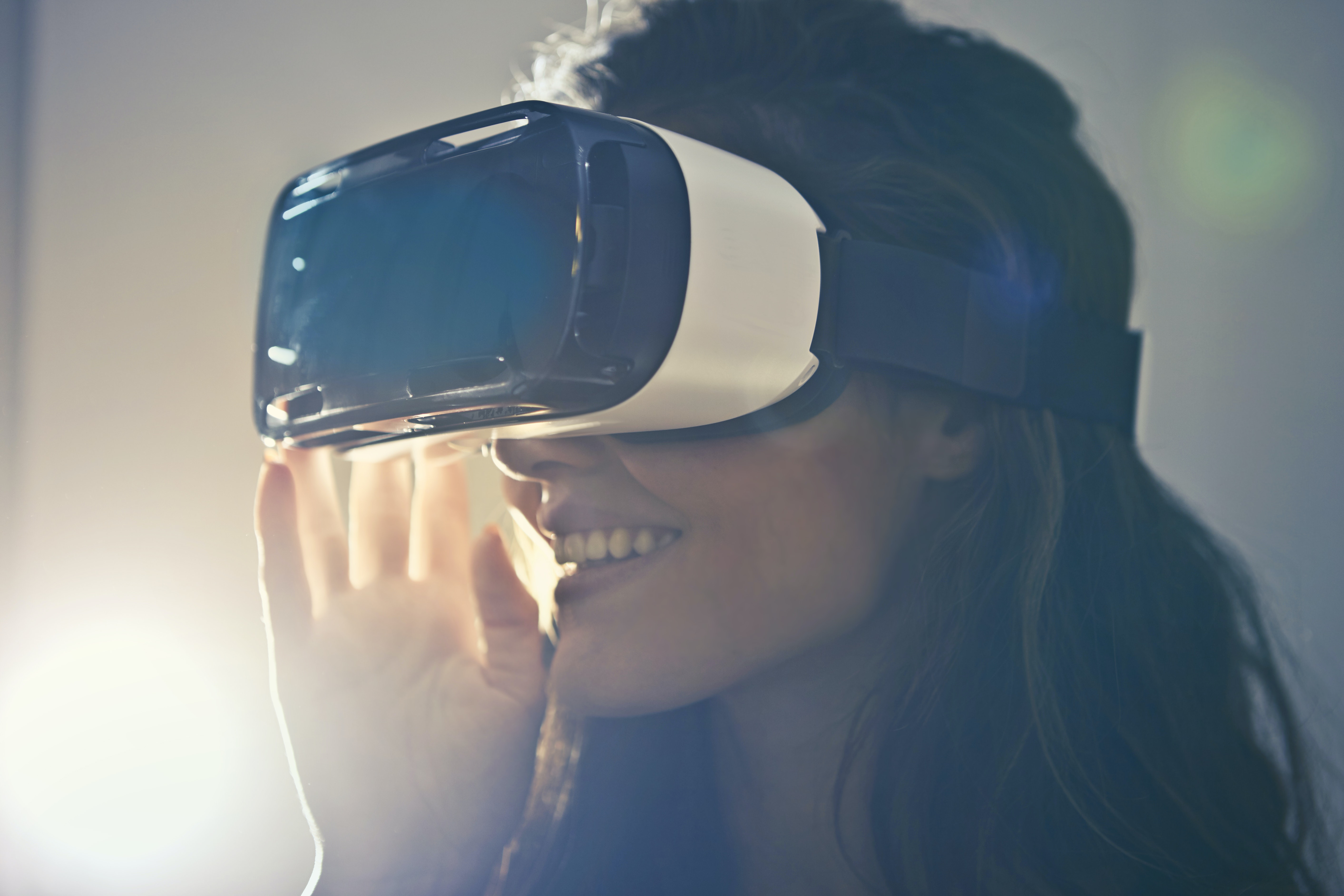 A woman wearing a Virtual Reality headset:
