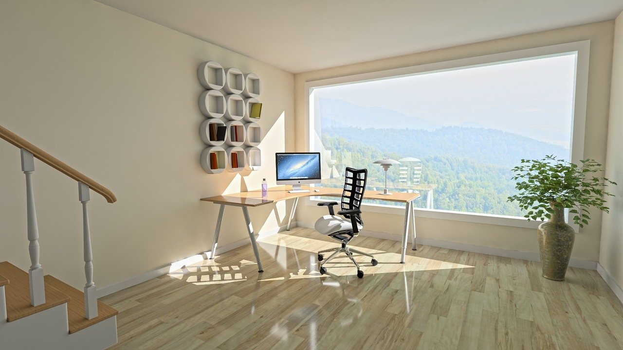 Creating inspiring space in our room: An office with a computer and desk overlooking a window